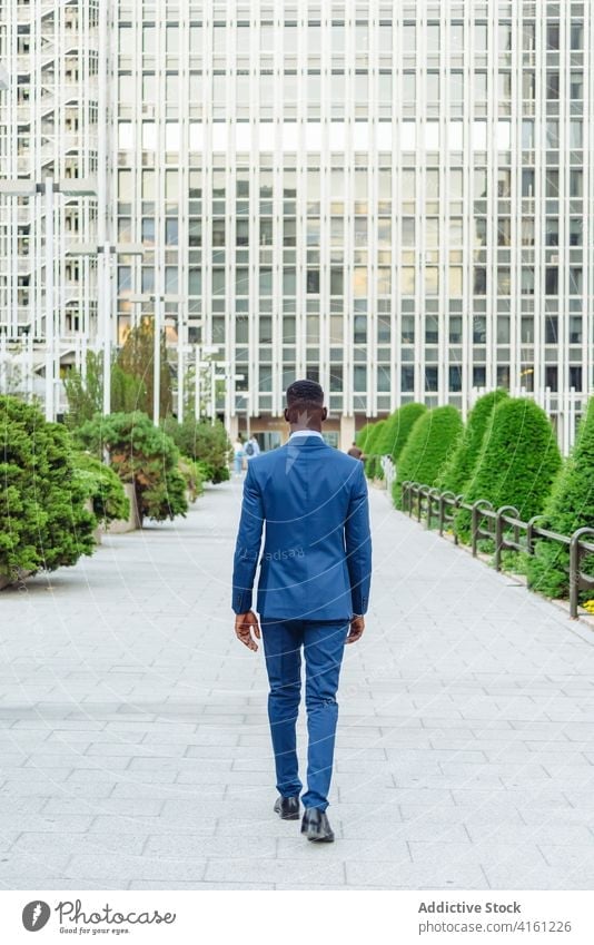 Black businessman in formal suit standing in city confident urban modern elegant executive success professional adult male entrepreneur african american black