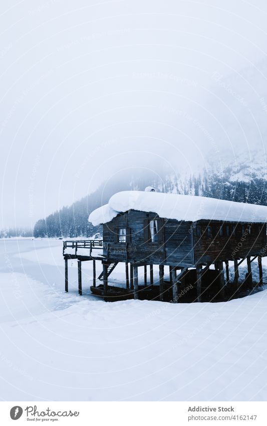 Snowy landscape of mountain valley in wintertime house snow cold snowfall lonely snowstorm nature severe weather climate frozen snowdrift season environment