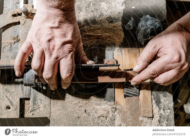 Male carpenter working with wood in garage woodworker workshop lumber man carpentry detail old workbench industry manual skill craftsman tool job timber