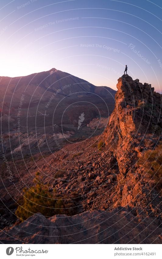 Unrecognizable traveler standing in mountain valley explorer landscape vacation admire highland sunlight spectacular rocky spain tenerife canary islands stone