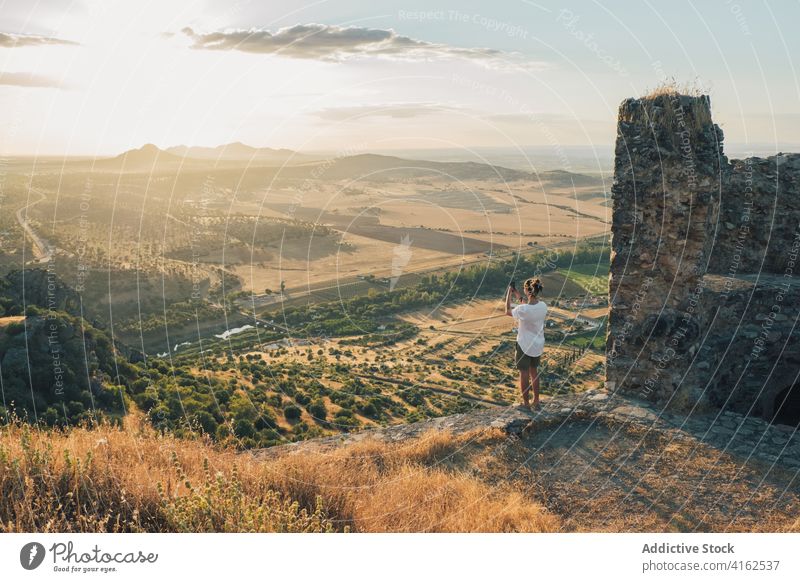 Unrecognizable person standing on hilltop and taking photos of valley take photo photographer smartphone nature wanderlust travel amazing traveler device