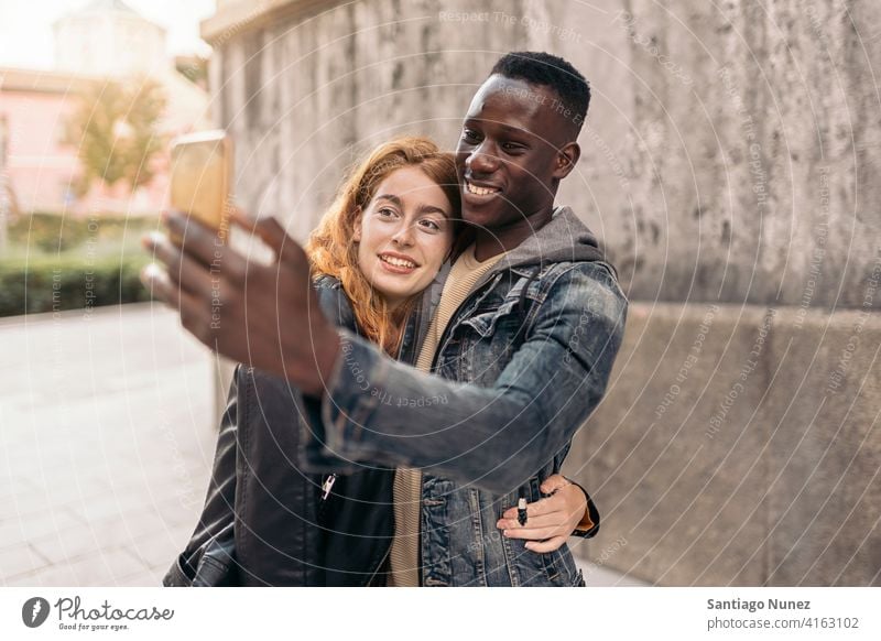 Couple Taking Picture taking picture selfie front view portrait relationship multi-racial black man caucasian multi-cultural multi-ethnic together standing