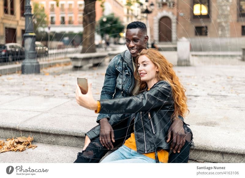 Couple Taking Picture taking picture selfie front view portrait relationship multi-racial black man caucasian multi-cultural multi-ethnic together boyfriend