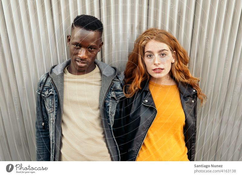 Ginger Head Woman and Afro Boy looking at camera two portrait ginger head woman male front view relationship multi-racial black man caucasian multi-cultural