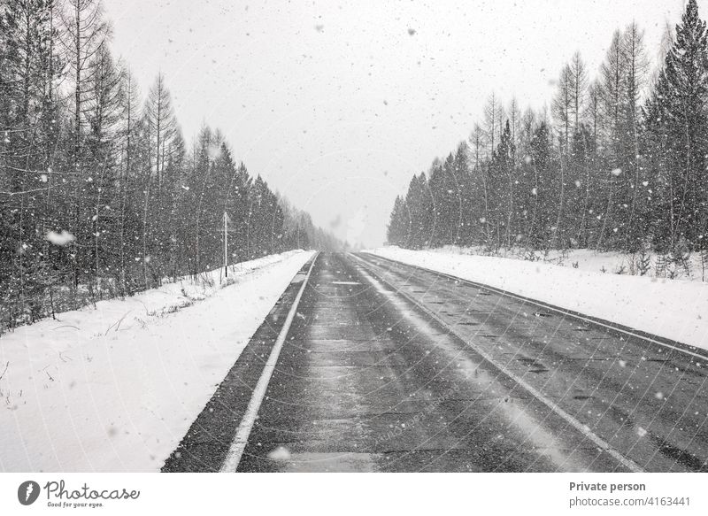 Winter driving - Winter road Country road leading through winter forest landscape, snowing car ice snowy truck travel service curve cold fast season dangerous