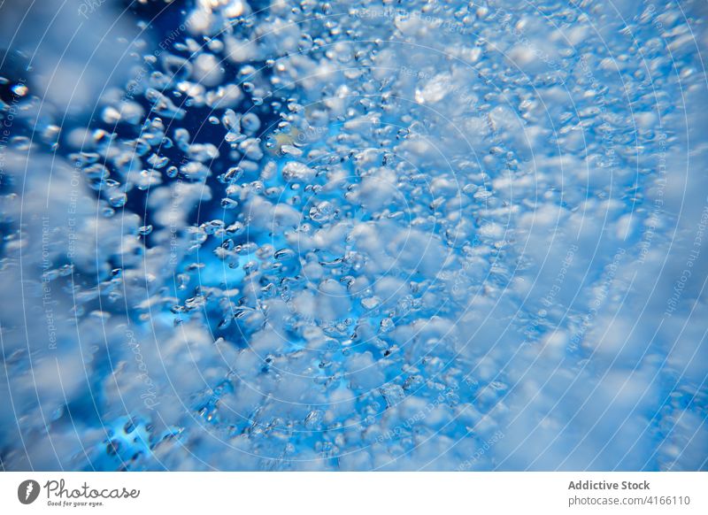 Abstract background with air bubbles in blue water clean underwater aqua abstract transparent blob splash flow liquid vibrant pool vivid clear fluid wet pure