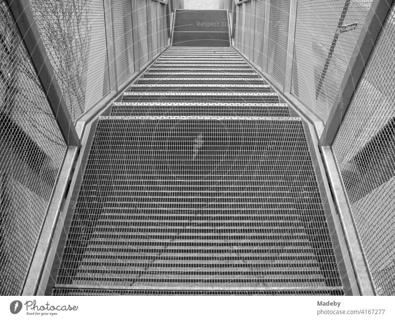 Staircase made of steel and wire mesh at the observation deck of the harbour crane "Blauer Kran" at the old harbour in Offenbach am Main in Hesse, photographed in traditional black and white