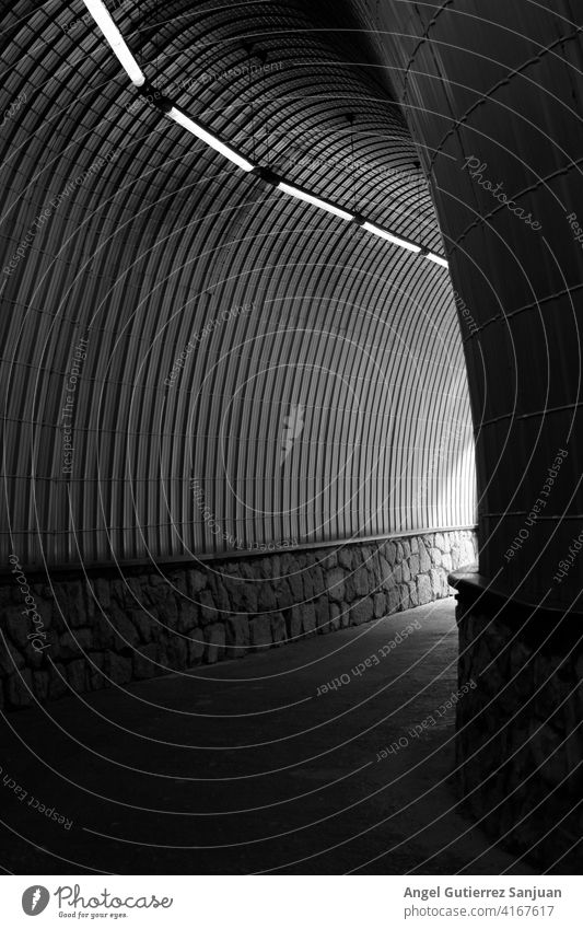 black and white tunnel with lights and stones way abstract detail line outdoors road architecture artistic auto automobile curve drive driving fast grey highway