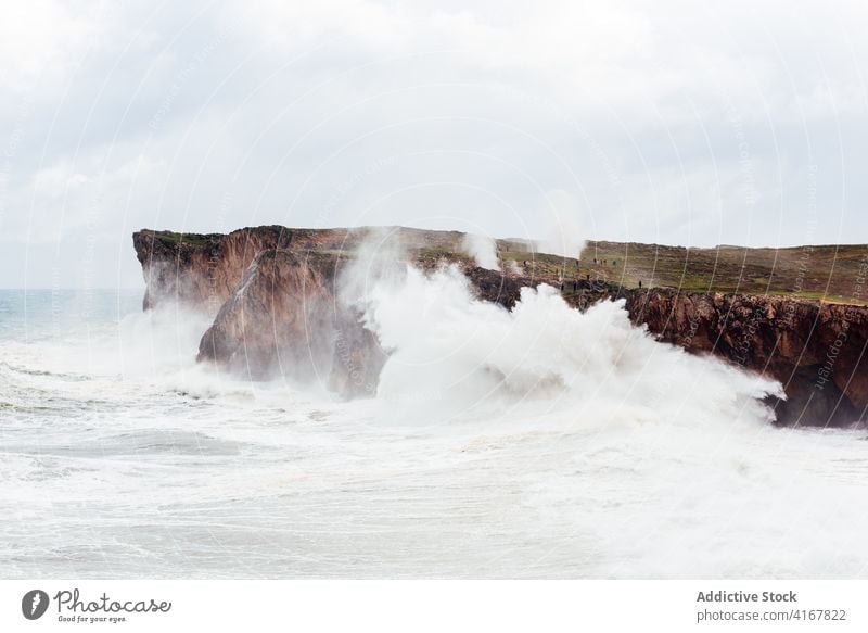 Stormy sea near rocky cliff stormy foam wave seascape power water roll scenery spectacular rough picturesque landscape majestic splash sunny stone nature scenic