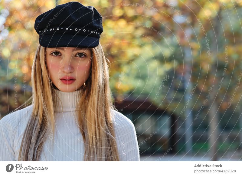 Millennial woman in trendy cap in autumn park style hat fashion urban casual young female blond outfit season lifestyle lady fall modern teenage millennial