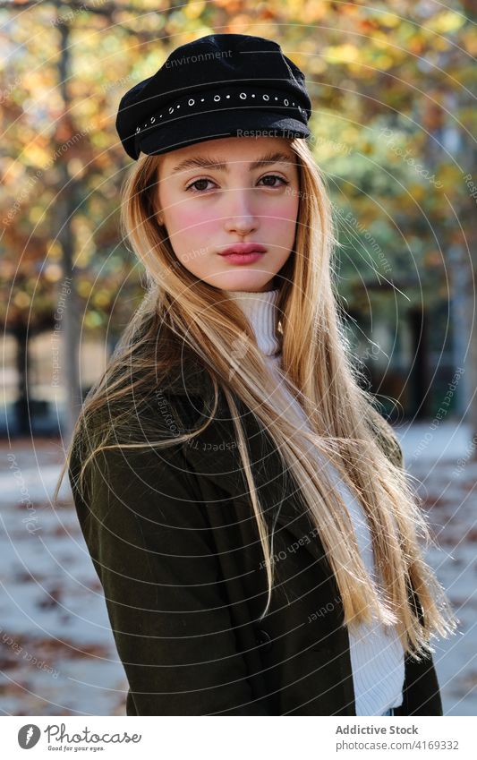 Millennial woman in trendy cap in autumn park style hat fashion urban casual young female blond outfit season lifestyle lady fall turtleneck modern teenage