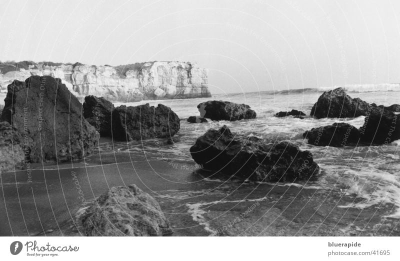 Rocky coast near Portugal Ocean Beach Black White Moody Horizon Coast Water Sand Stone Fragment Bay Idyll
