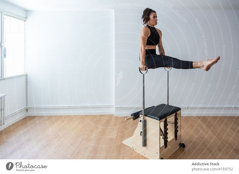 Pilates reformer chair woman fitness yoga gym exercise. Correction of  musculoskeletal system, beautiful body. Correct posture Stock Photo - Alamy