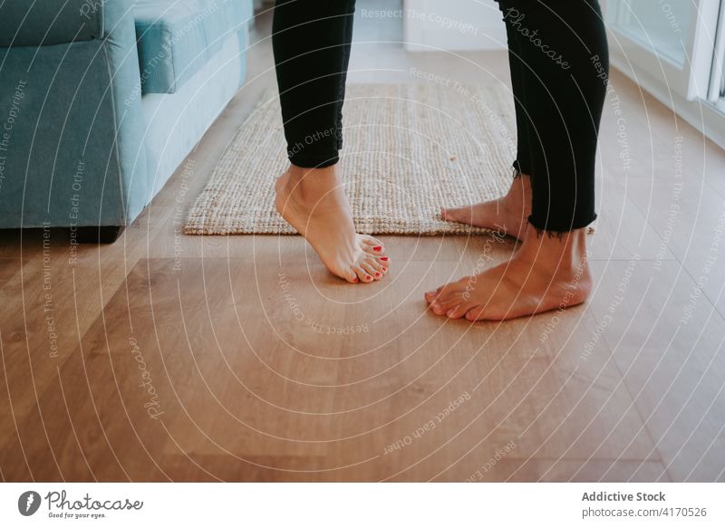 Barefoot couple standing at home barefoot leg tiptoe love floor wooden together apartment harmony relationship rest house serene comfort peaceful affection