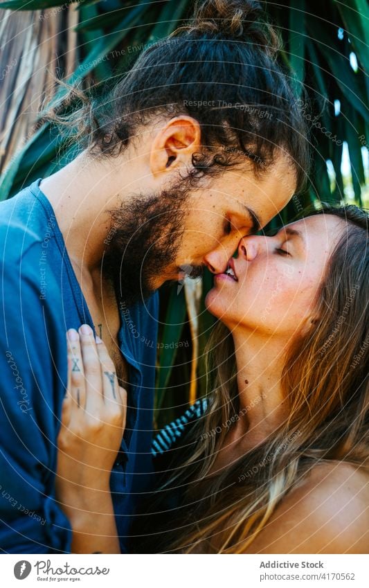 Tender couple hugging in nature romantic gentle face to face touch tender love relationship together park multiracial multiethnic diverse tropical fondness