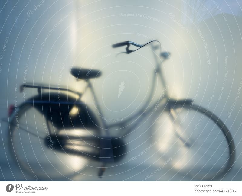 Silhouette of a bicycle Bicycle Shop window Reflection blurriness Light (Natural Phenomenon) hollandrad New Hazy Artificial light Subdued colour Store premises