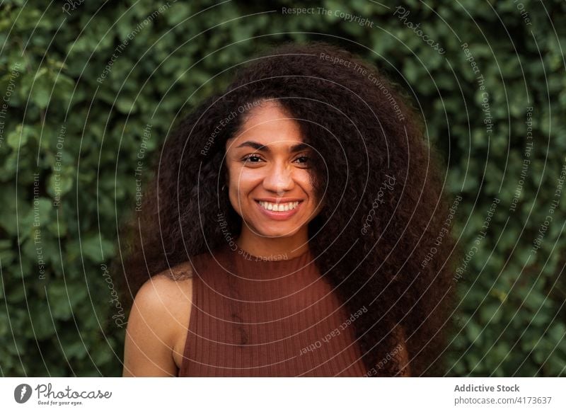 A happy black latin girl with green Box Braids hairstyle smiling at camera  Stock Photo - Alamy
