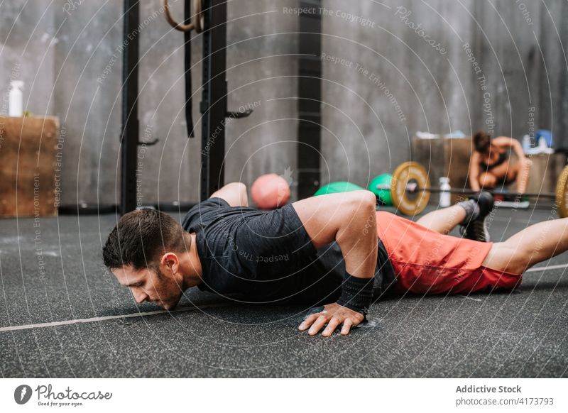 Sportsman doing push ups in gym workout exercise functional sportsman athlete training power male wellness fit physical wellbeing determine activity focus