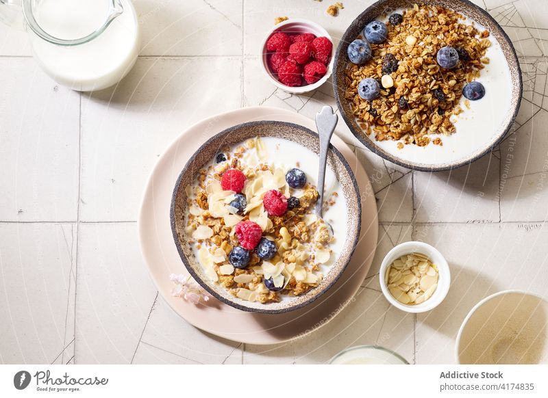 Breakfast with granola, berries and milk breakfast food healthy organic cereal fruit muesli berry bowl grain diet flake snack yogurt fresh natural sweet dessert