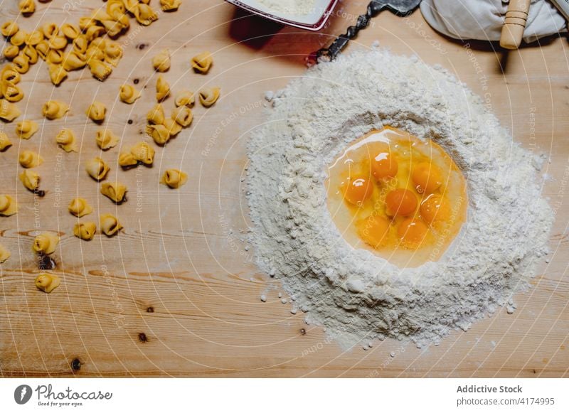 Ingredients for tortellini on wooden table ingredient italian food flour egg dough raw cook dumpling homemade pastry prepare culinary italian cuisine domestic