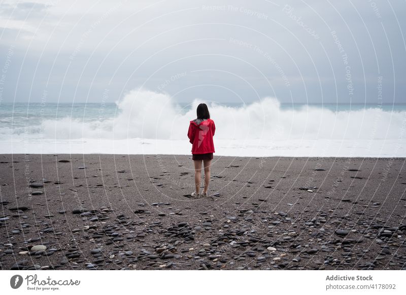 Traveler standing on shore of stormy sea traveler woman beach wave cloudy roll tourist seascape female hualien city taiwan admire wet ocean sky coast gray