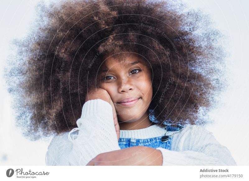 Smiling black teen girl with curly hair afro kid positive smile denim child portrait hairstyle female african american ethnic teenage cheerful content happy