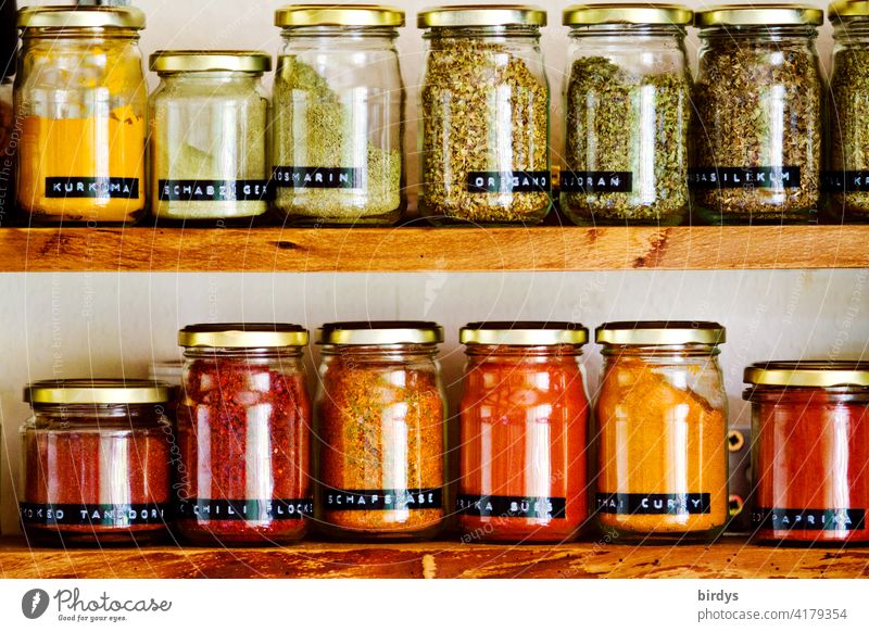 Spices in screw jars in a spice rack spices Spice rack Glasses boil Kitchen season Herbs and spices Nutrition flavor Spicy kitchen herbs screw lenses Vielvalt