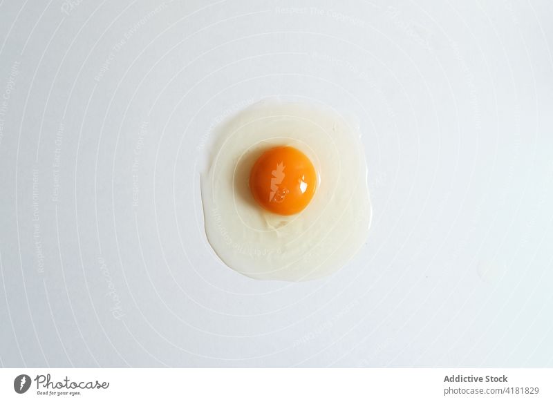 Raw egg on white background raw healthy food fresh yolk organic product uncooked natural studio minimal ingredient chicken hen bright nourish nutrition nutrient