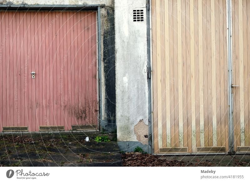 Dilapidated old garage doors in pastel colours in Lemgo near Detmold in East Westphalia-Lippe Garage Garage door TIR Old scruffy run-down Past Downfall Decline