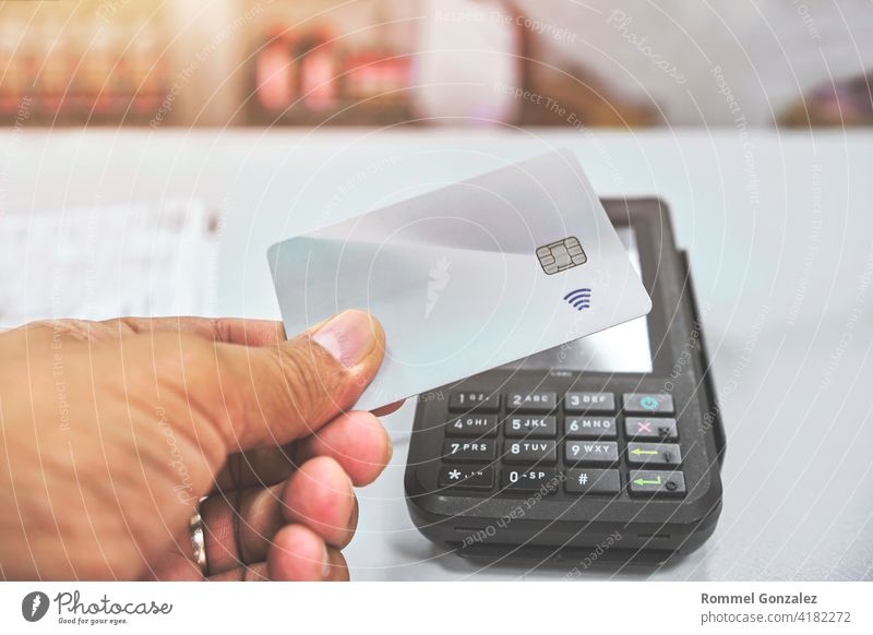 Close up of unrecognizable customer doing a contactless payment credit card store paying shopping banking working wireless bill paying bills transmission