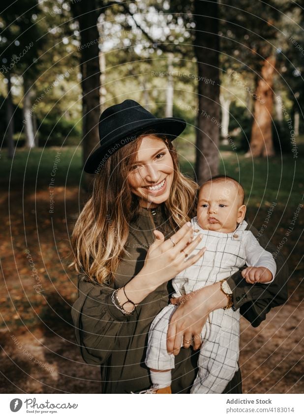 Happy mother with baby enjoying time together in park love hug child motherhood happy affection embrace parent lifestyle kid care mom fondness tender bonding