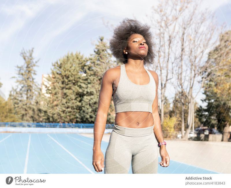 Concentrated black athlete in sportswear in neon light - a Royalty Free  Stock Photo from Photocase