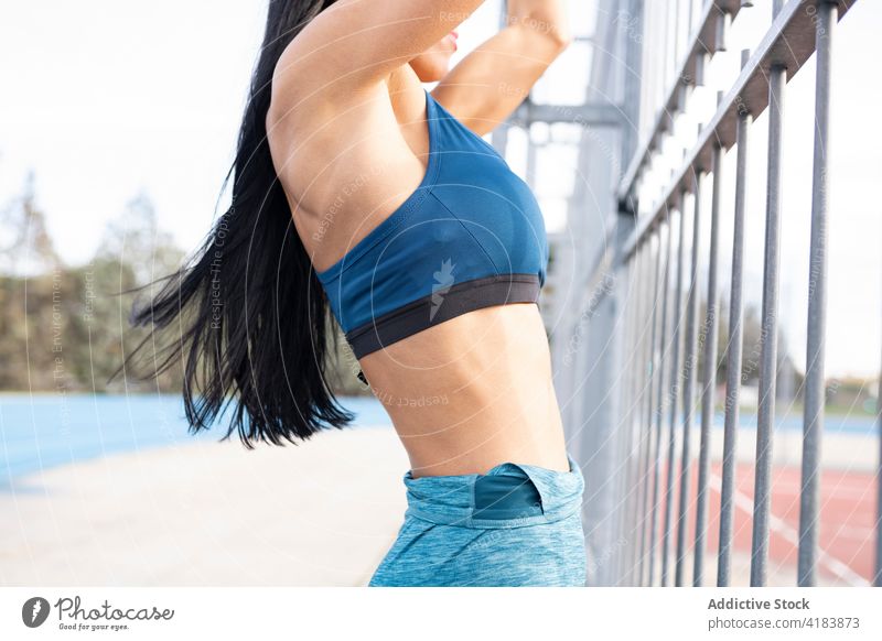 Crop fit sportswoman doing pull ups during workout - a Royalty