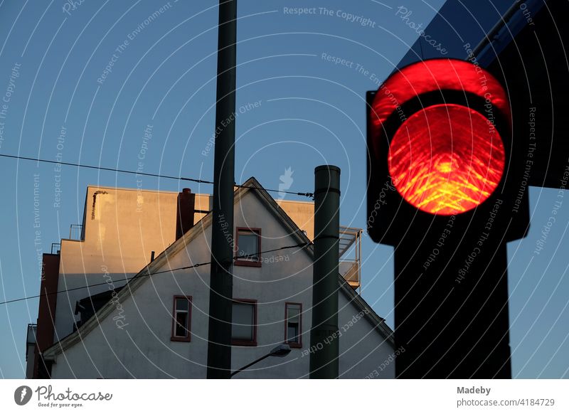 Red traffic light at blue hour with blue sky and evening sun at the Hanauer Landstraße in the Ostend of Frankfurt am Main in Hesse, Germany Traffic light