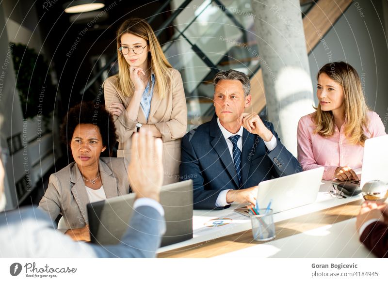 Multiethnic group of business people working together and preparing new project on a meeting in office black brainstorming businessman businesswoman colleagues