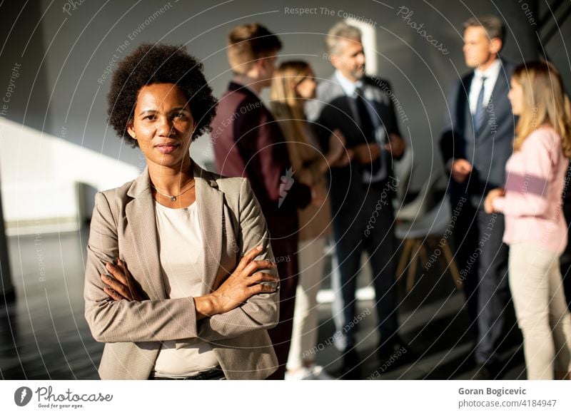 African American business woman standing in front of her team in office african agent american bag black businesswoman career colleagues college corporate
