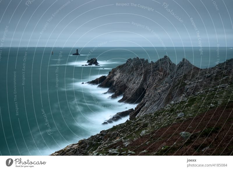 Dark, rocky coast with surf and lighthouse Lighthouse Hope Waves Wanderlust Longing Watchfulness Black Deserted France Rock Horizon Clouds Sky Subdued colour