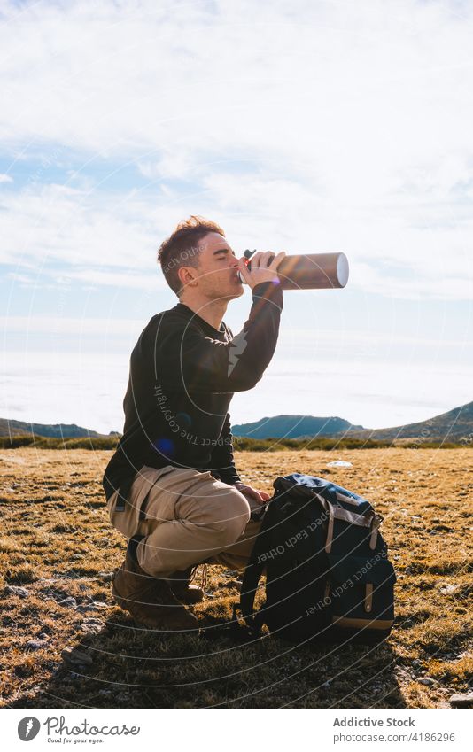 Free Photo  Man drinking from thermos