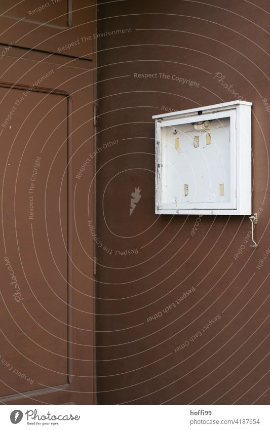 empty notice box in front of a brown entrance of a pub business expense Closed Roadhouse Brown entrance area dreariness Entrance Notice bankruptcy