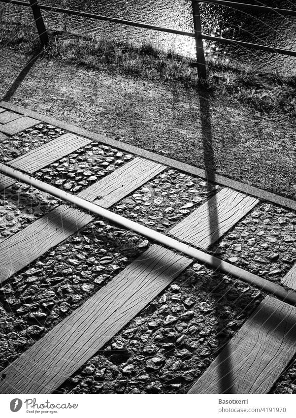 Old railway tracks on the promenade at the Duisburg inner harbour in black and white Inner Harbour Track rails Promenade Tourism Town Railroad Transport