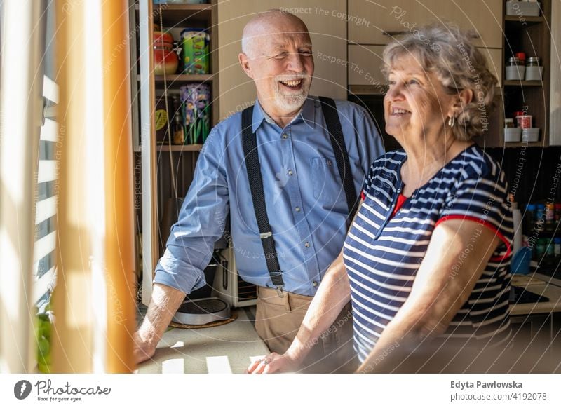 Happy senior couple together at home real people candid genuine woman mature female love bonding Caucasian elderly house old aging domestic life grandmother