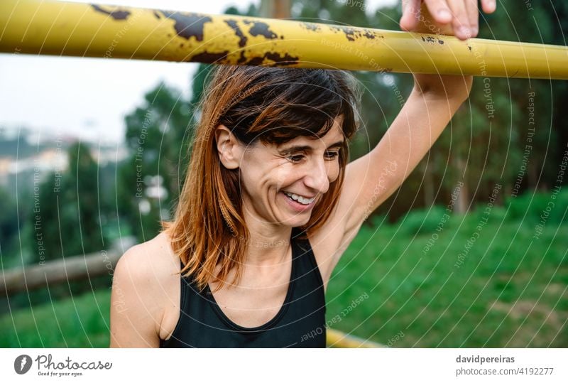 Happy and tired athlete woman after training sportswoman happy smiling proud achievement success recovery supported effort bar slender satisfied exercise