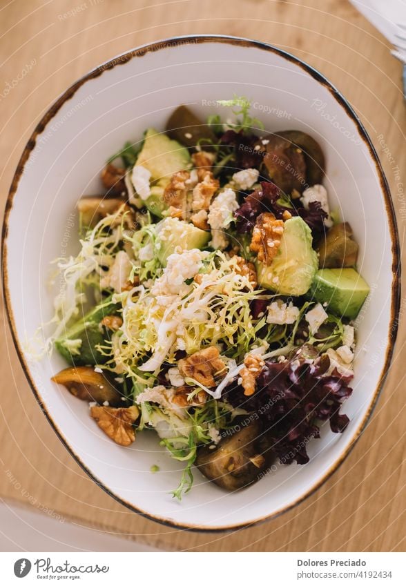 Gourmet salad of avocado, walnuts, tomato and green sprouts. Served in a fancy restaurant vitamin recipe colorful cucumber balsamic eat cheese dressing onion