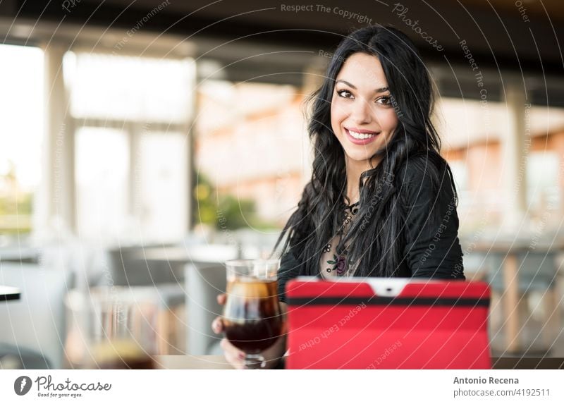 Pretty dark haired woman looking at camera and drinking coke young attractive 20s joy people person youth urban women pretty pretty people relaxing