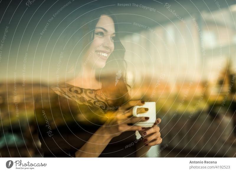 beautiful woman drinks a coffee while looking through the window of a bar young attractive 20s joy people person youth urban women pretty pretty people smile
