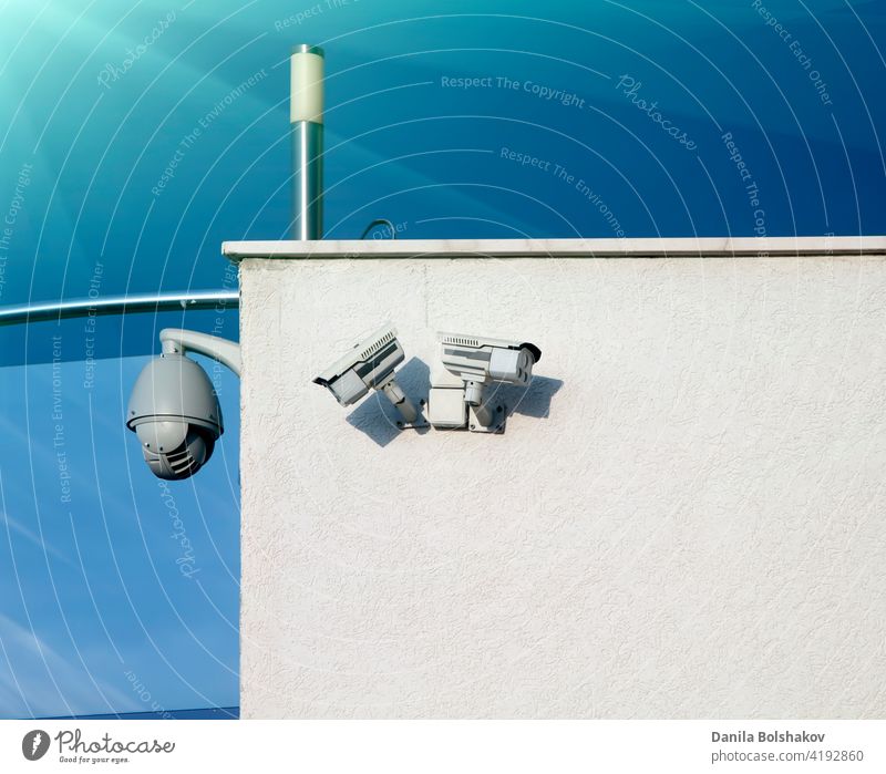 Security cameras on the wall with copy space. security surveillance cctv video building system white watching safety suspicious monitoring spy technology nobody