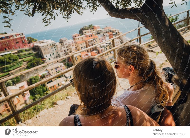 Two young women under the olive tree overlooking Manarola Olive tree Young woman Blonde Sun Sunlight Tree portrait Smiling pretty vacation Summer Summer Feeling