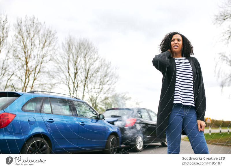 Female Driver With Whiplash Injury Standing By Damaged Car After Road Traffic Accident woman driver car accident wreck crash whiplash injury injured neck pain