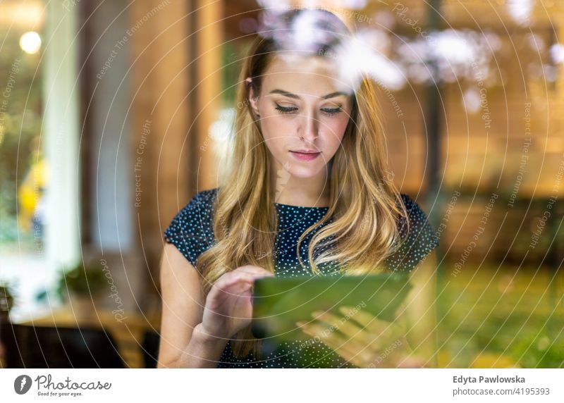 Young businesswoman using digital tablet in her office girl people Entrepreneur successful professional young adult female lifestyle indoors millennial