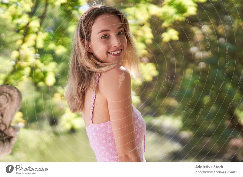 Positive teen woman in green park teenage enjoy positive cheerful optimist carefree delight individuality female tree smile charming summertime adolescent glad